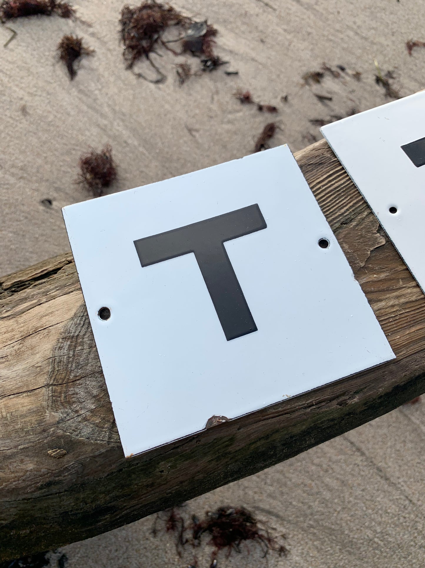 Emailleschild mit dem Buchstaben T